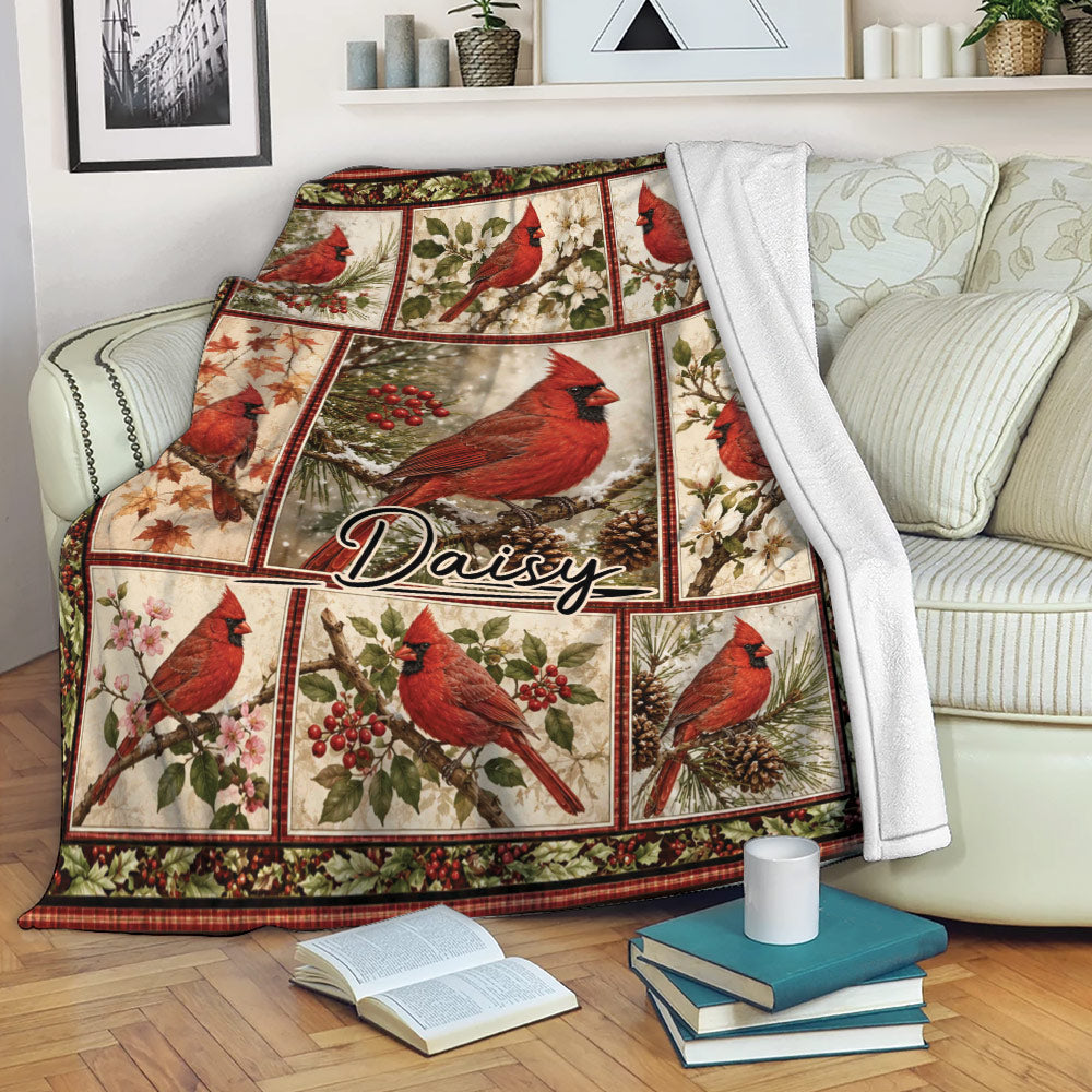 Cardinal throw blanket draped over a sofa with red bird artwork and cozy reading nook decor