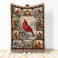 Cardinal blanket featuring red birds, snowy woodland scenes, a lantern, birdhouse, and holiday artwork