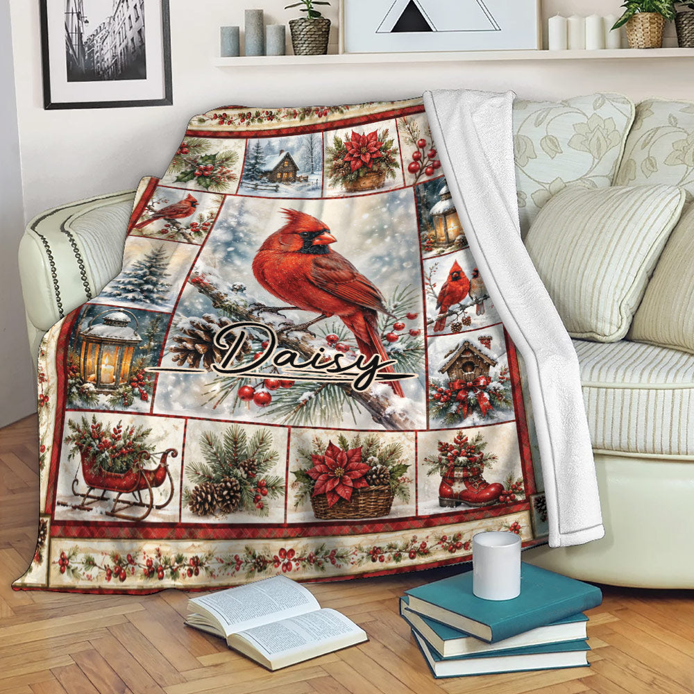 Cardinal throw blanket displayed on a sofa with snowy winter scenes, greenery, lanterns, and festive red accents