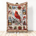 Christmas cardinal blanket featuring a red bird, snowy cabin, poinsettias, holly, lanterns, and winter decor