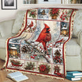 Red cardinal Christmas blanket draped over a couch with snowy branches, poinsettias, sleigh decor, and birdhouses