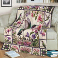 Floral hummingbird blanket styled over a sofa with botanical artwork and books