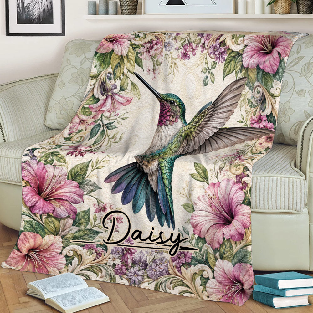 Hummingbird and hibiscus floral blanket styled across a living room sofa