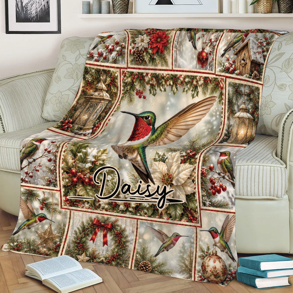 Close lifestyle view of a hummingbird throw blanket on a sofa with winter berries, ornaments, and lanterns