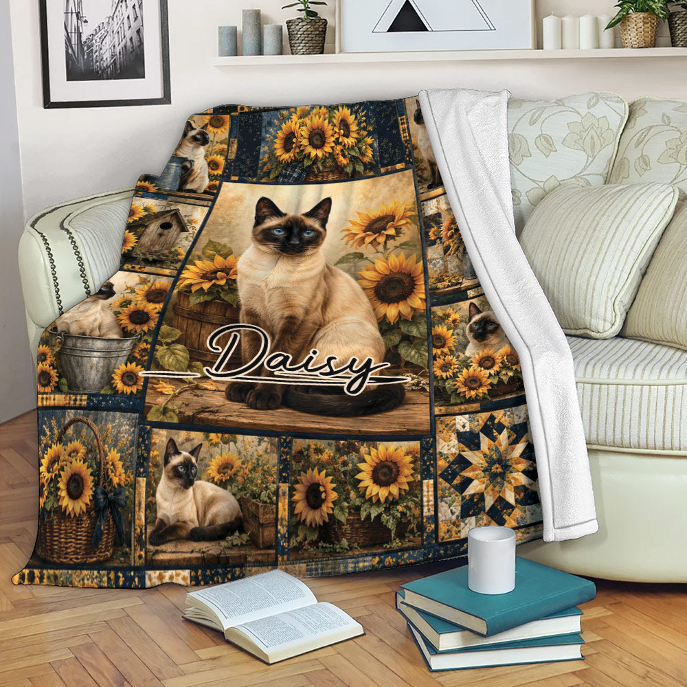 Siamese cat throw blanket draped over a sofa with sunflower and rustic country artwork