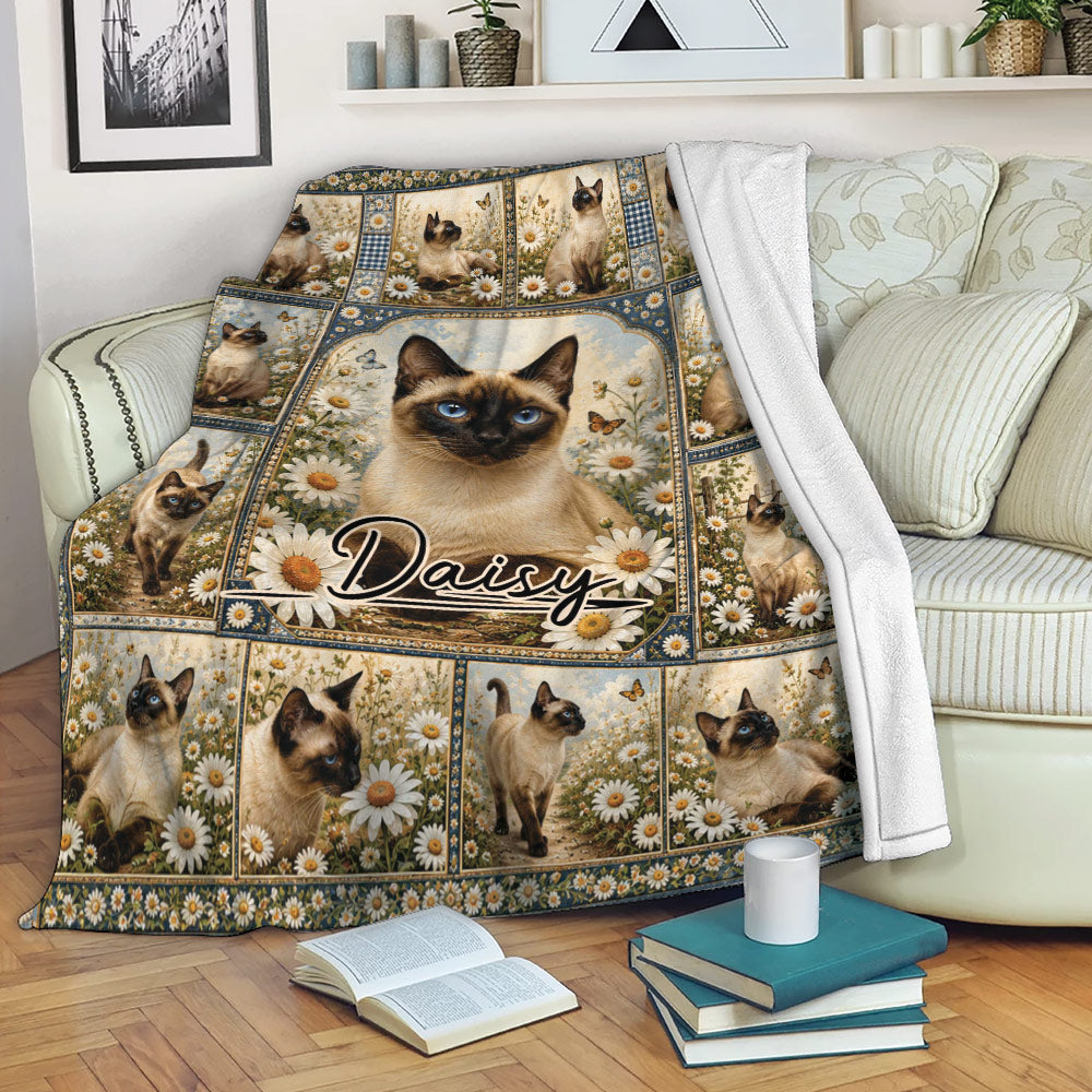 Siamese cat throw blanket draped over a sofa with floral artwork, butterflies, and a cozy reading setting