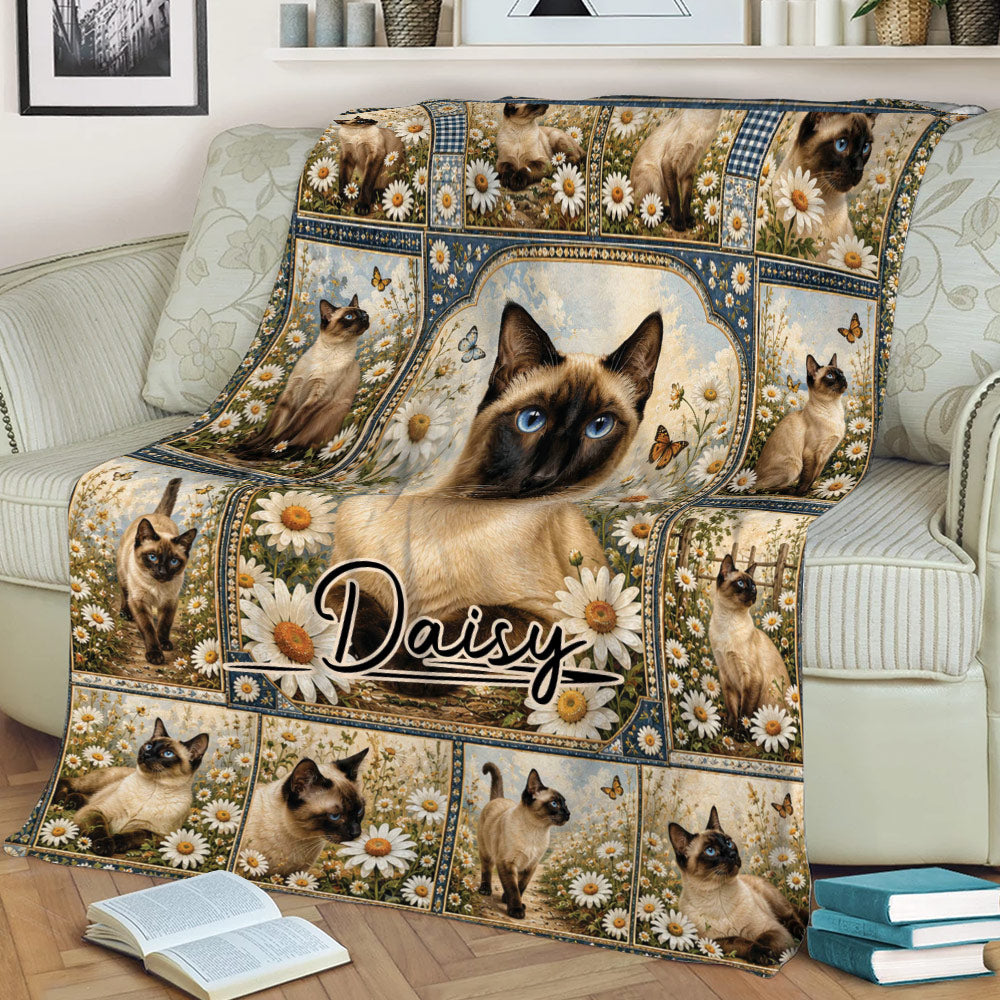 Close lifestyle view of a Siamese cat blanket featuring blue-eyed cats, daisies, and decorative vintage frames