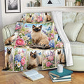 Siamese cat throw blanket draped over a sofa with floral panels, butterflies, and cozy reading decor