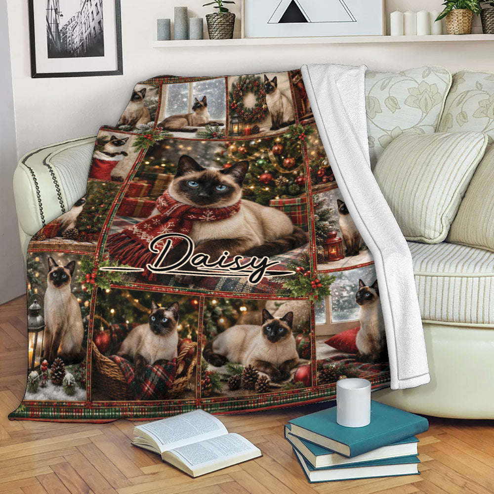 Siamese cat Christmas throw blanket draped over a sofa in a cozy living room setting