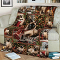 Close lifestyle view of a Siamese cat Christmas blanket styled across a sofa with holiday artwork