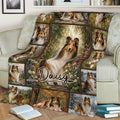 Sheltie blanket draped over a sofa, showcasing floral woodland artwork and multiple dog portraits