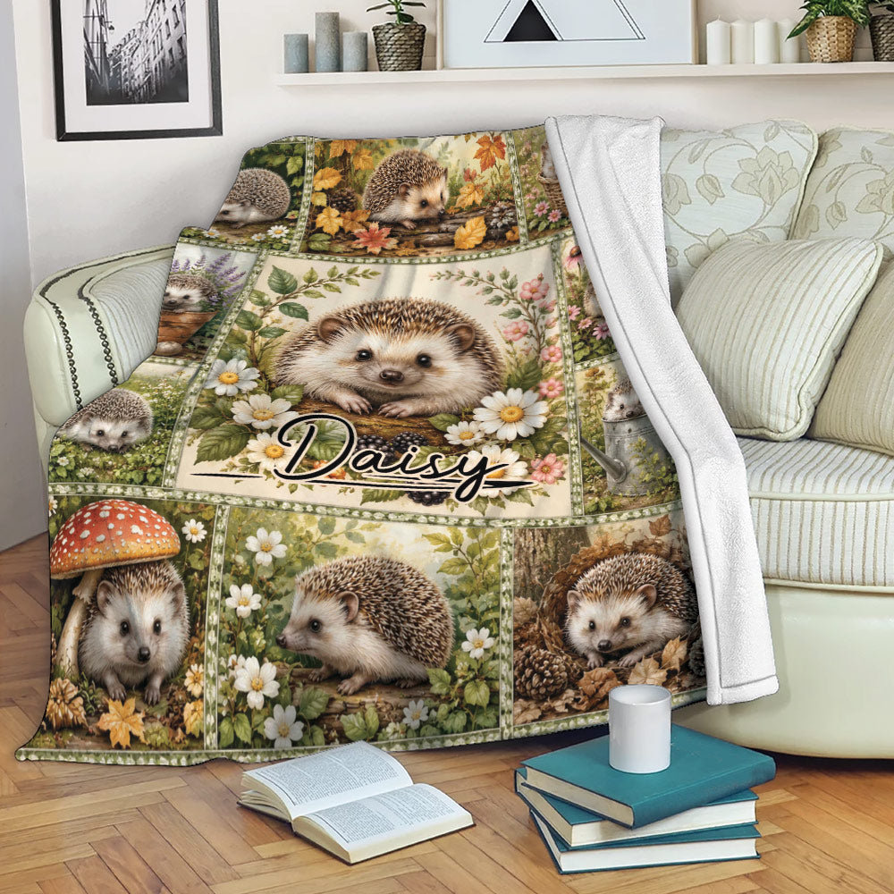 Hedgehog blanket draped over a sofa, showing floral woodland artwork in a cozy living room
