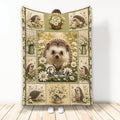Hedgehog throw blanket displayed upright with daisy garden artwork and multiple hedgehog illustrations