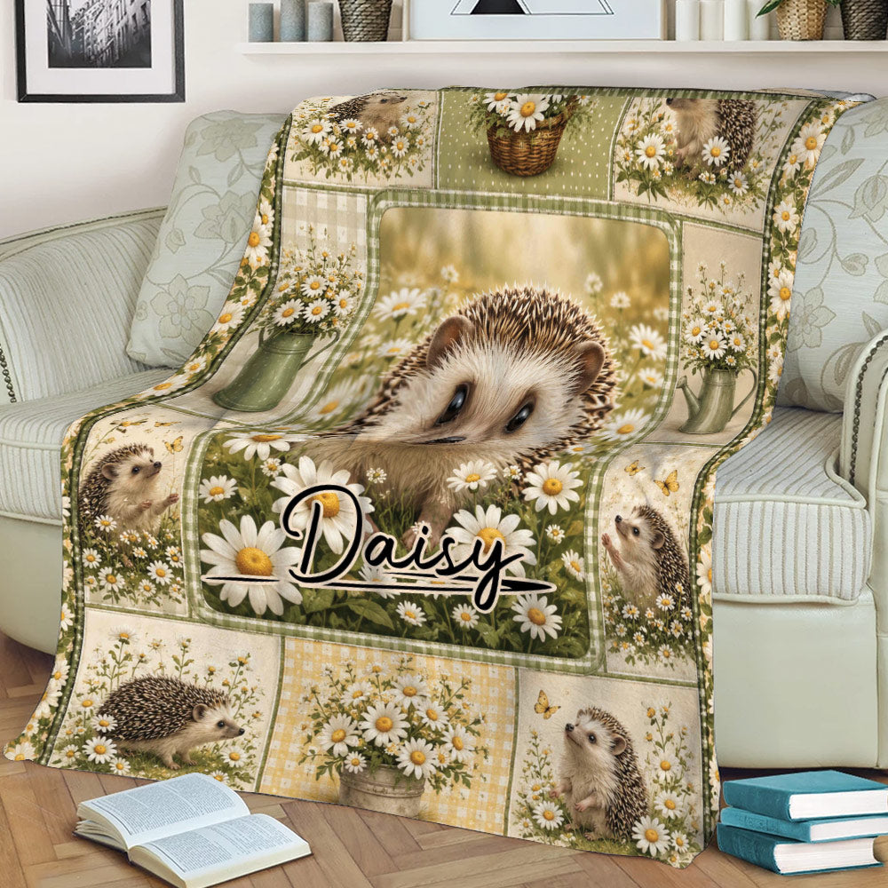 Close view of a hedgehog throw blanket featuring daisies, garden accents, and woodland artwork