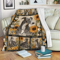 Greyhound blanket draped over a sofa with sunflower artwork and warm rustic floral accents
