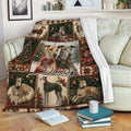 Christmas Greyhound throw blanket draped over a sofa with plaid dog scenes and holiday decor