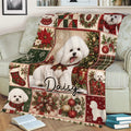 Close view of a Bichon Frise Christmas blanket with holiday gifts, ornaments, and greenery
