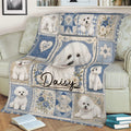 Bichon Frise blanket displayed on a sofa, featuring a large fluffy white dog and coordinated blue floral panels