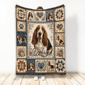Basset Hound throw blanket featuring a central dog portrait, floral hearts, paw prints, and rustic blue artwork