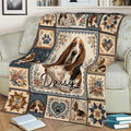 Basset Hound throw blanket displayed on a couch with floral borders, heart motifs, and heritage-inspired artwork