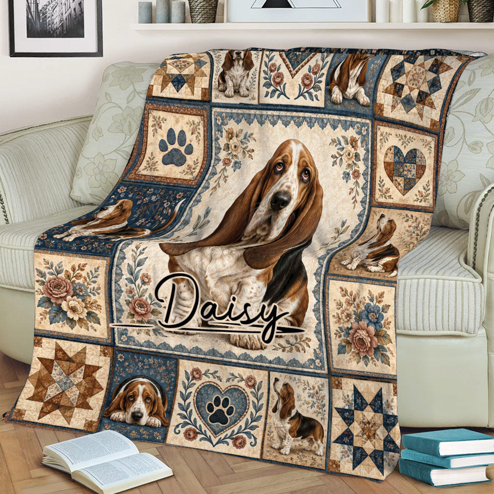 Basset Hound throw blanket displayed on a couch with floral borders, heart motifs, and heritage-inspired artwork