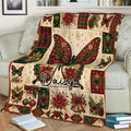 Vintage butterfly throw blanket displayed on a couch with poinsettias, ornaments and Christmas greenery