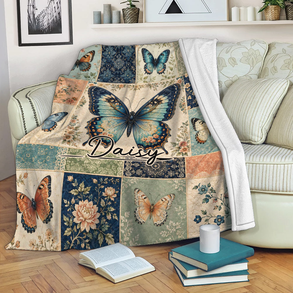 Butterfly throw blanket draped over a sofa with vintage floral patchwork artwork