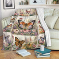 Butterfly throw blanket draped over a sofa with colorful flowers and garden artwork