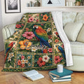 Parrot throw blanket draped over a sofa with tropical floral artwork and colorful birds