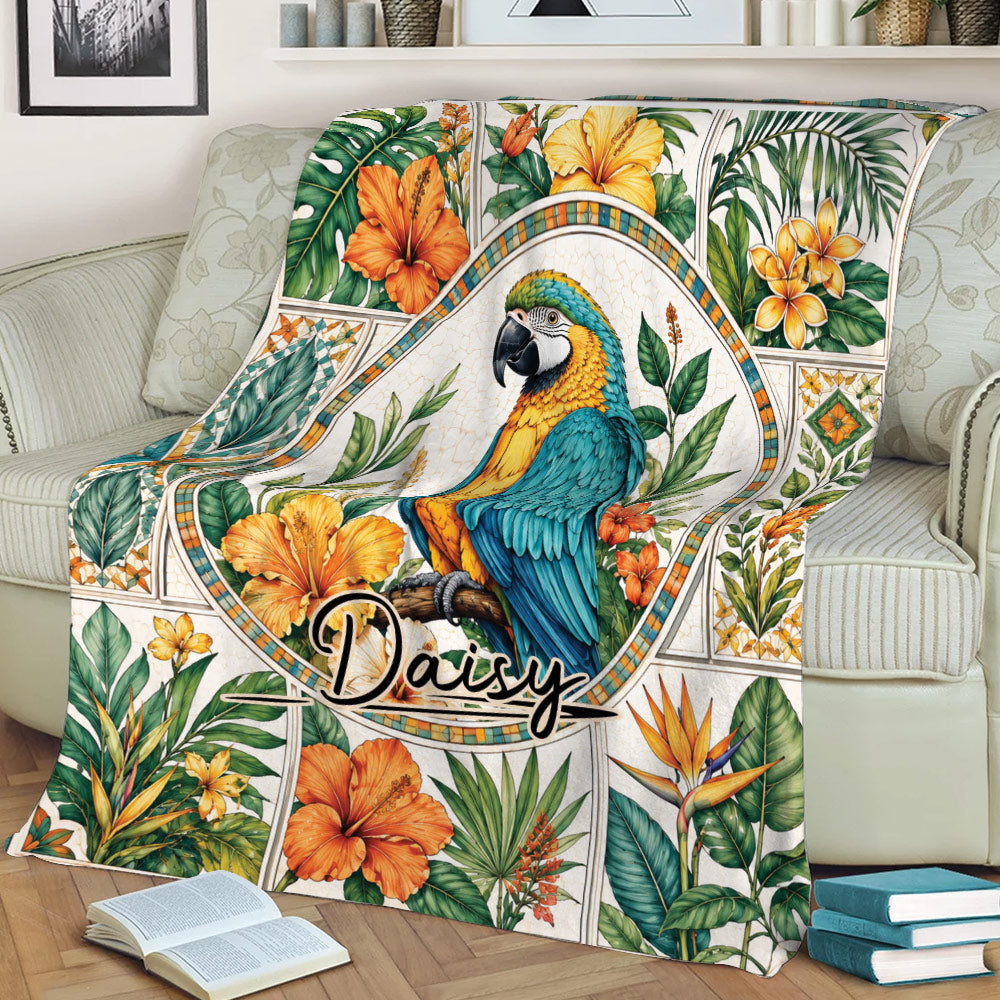 Colorful parrot blanket displayed on a sofa, surrounded by tropical flowers and foliage