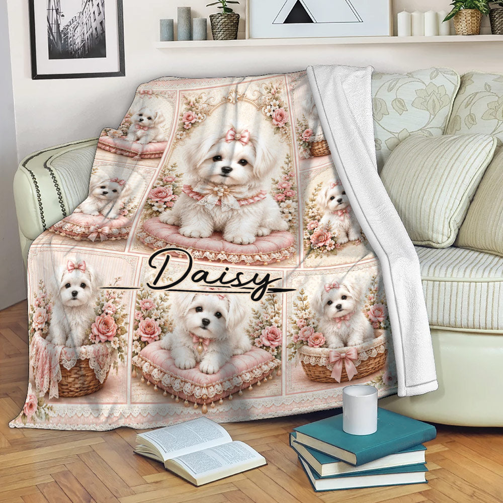 Maltese blanket draped over a sofa, featuring white dogs, pink floral panels, and romantic cottage-style decor