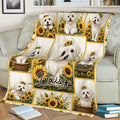 Maltese dog throw blanket styled across a sofa with sunflower panels and warm cottage-inspired artwork