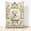 Maltese throw blanket displayed upright with white dogs, floral wreaths, and green patchwork artwork
