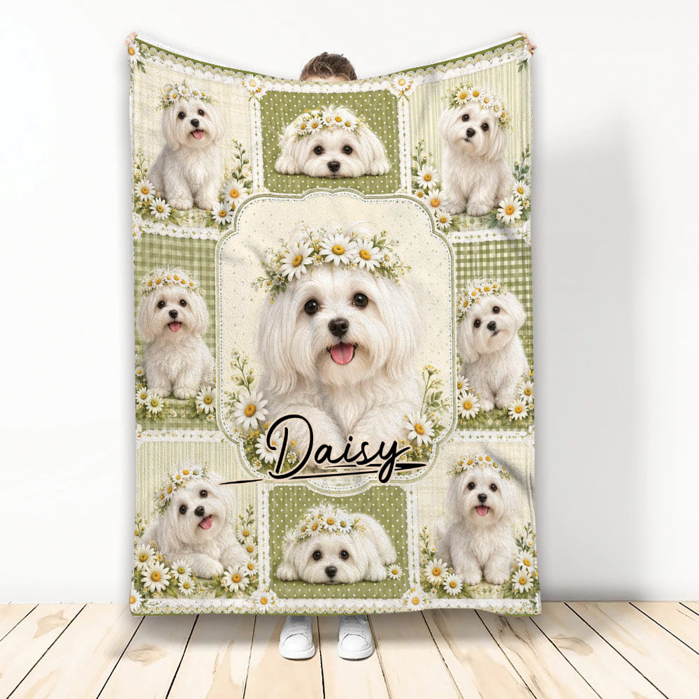 Maltese throw blanket displayed upright with white dogs, floral wreaths, and green patchwork artwork