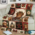 Close lifestyle view of a Christmas Highland Cow blanket covering a sofa with holiday artwork