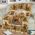 Rustic Highland cow blanket spread across a sofa with farm, wildflower, and sunflower artwork