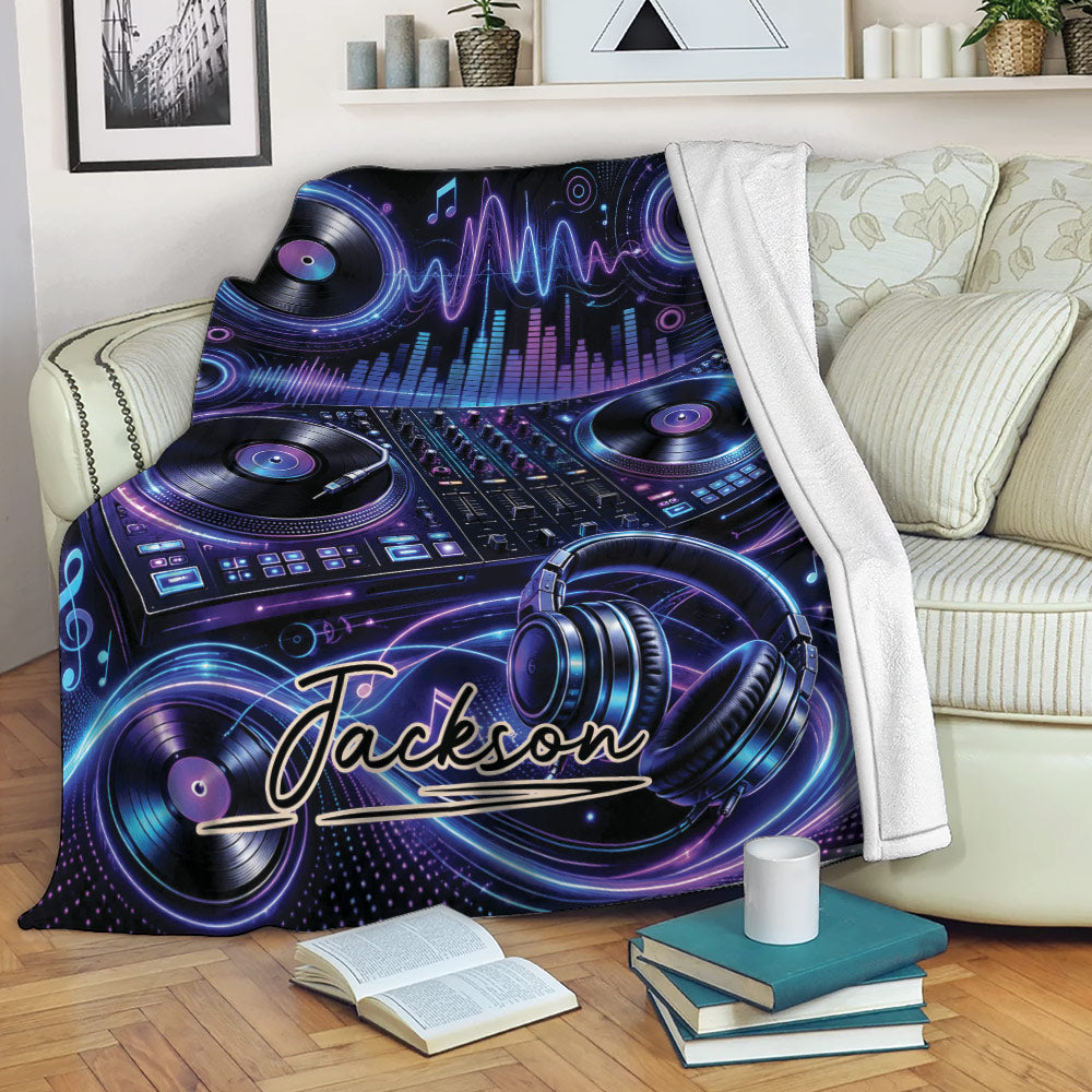 DJ blanket displayed on a sofa with turntables, headphones, audio controls, and glowing purple-blue music graphics