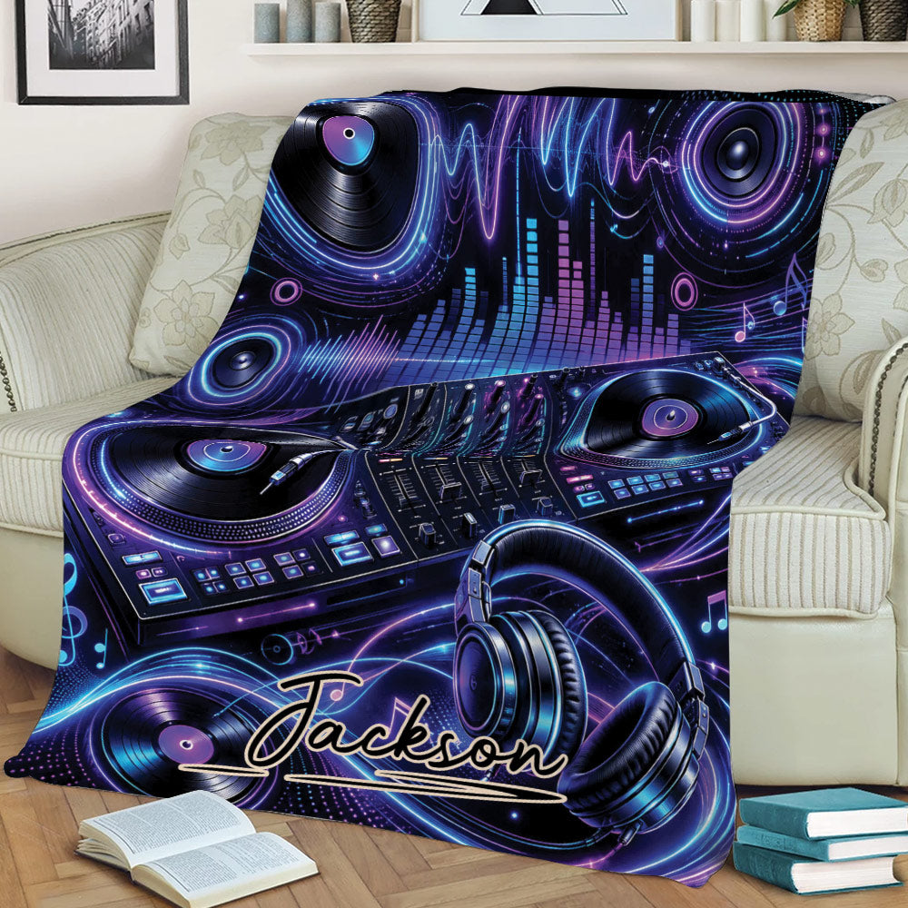 DJ throw blanket draped over a couch with turntables, mixer controls, headphones, and vibrant sound wave artwork