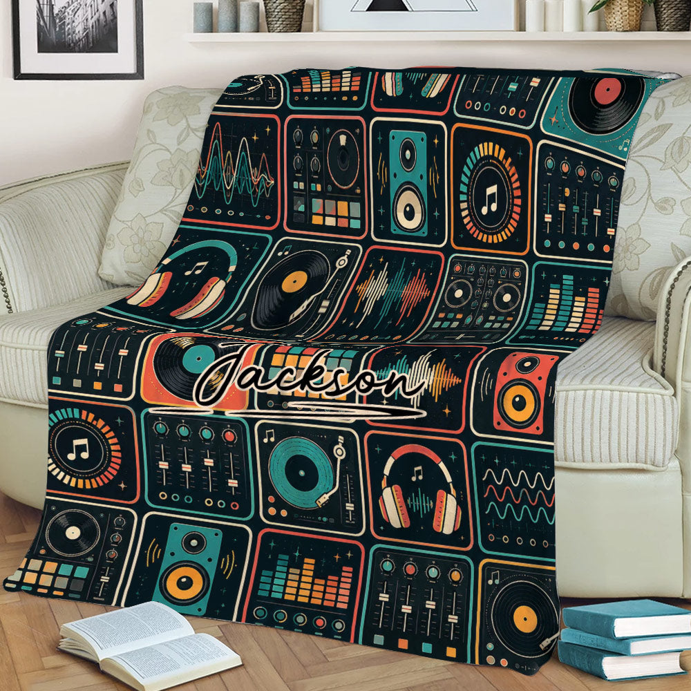 DJ throw blanket styled on a sofa, featuring retro audio equipment, vinyl records, speakers, and equalizer designs