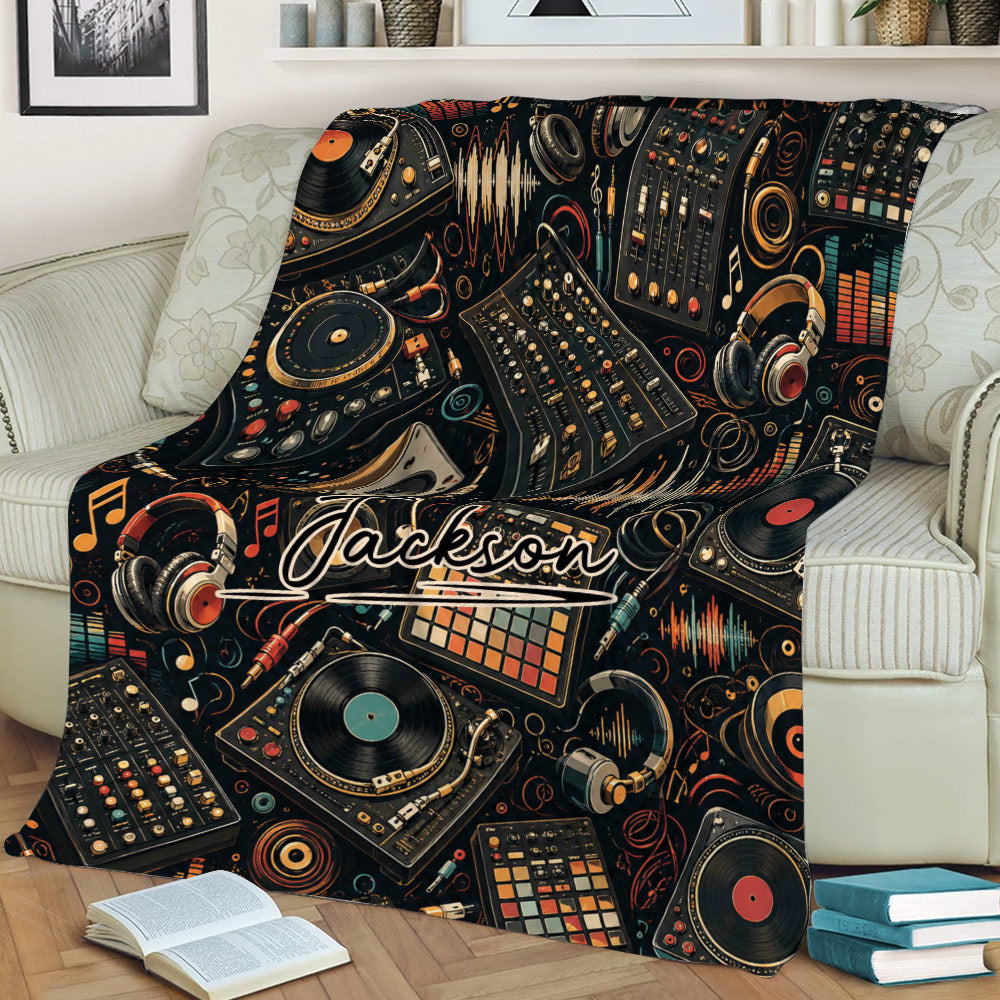 DJ blanket styled on a couch featuring turntables, mixing boards, headphones, records, and vibrant soundwave graphics
