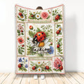 Ladybug throw blanket displayed vertically with floral panels, daisies, pink blooms, and botanical garden artwork