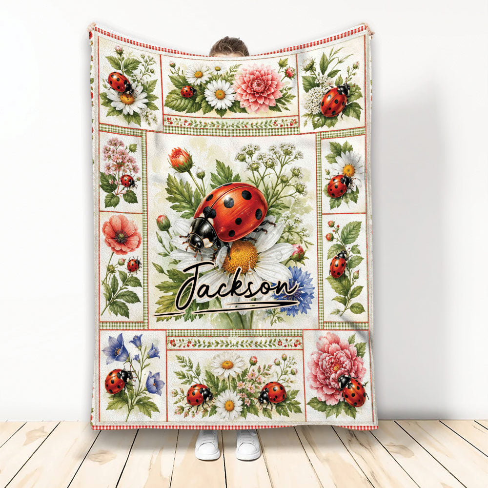 Ladybug throw blanket displayed vertically with floral panels, daisies, pink blooms, and botanical garden artwork