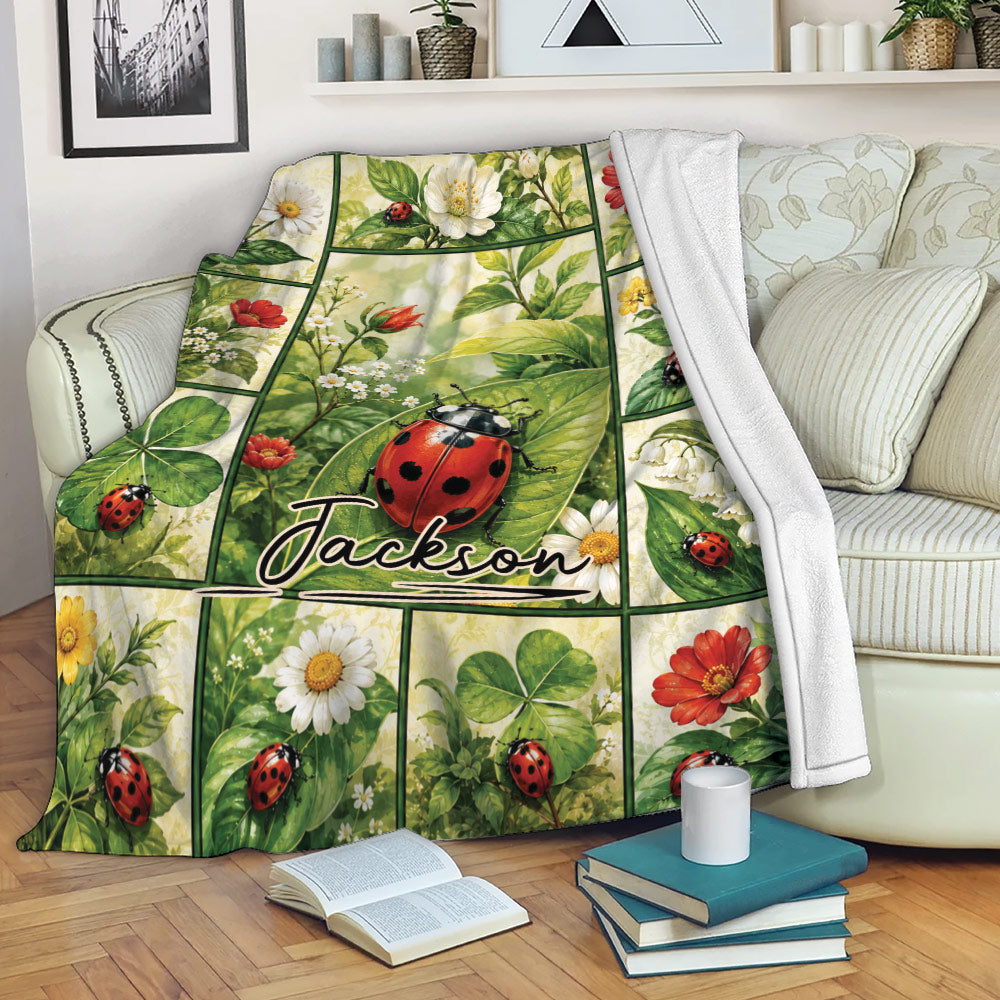 Ladybug throw blanket draped over a sofa with floral and leafy garden artwork