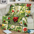 Floral ladybug blanket displayed across a sofa with colorful botanical panels