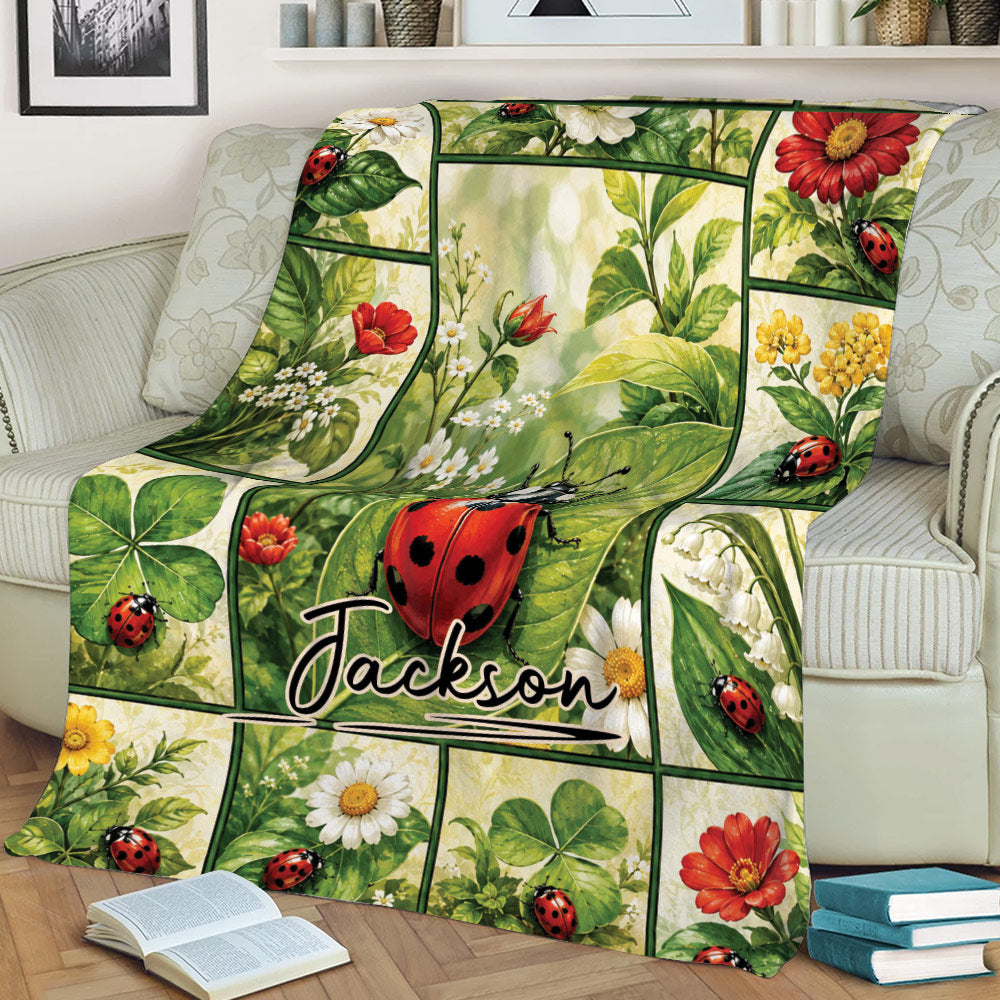 Floral ladybug blanket displayed across a sofa with colorful botanical panels