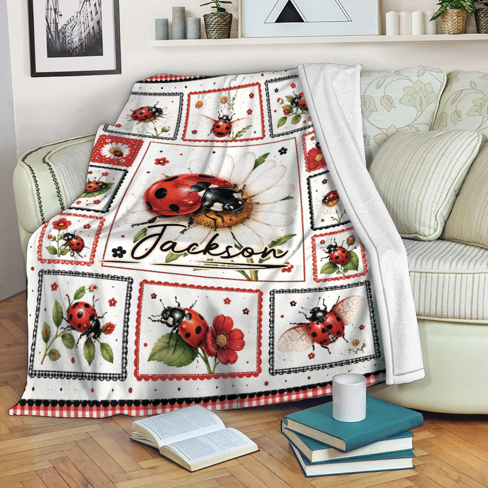 Ladybug throw blanket draped over a sofa with flowers, leafy accents, and framed insect illustrations