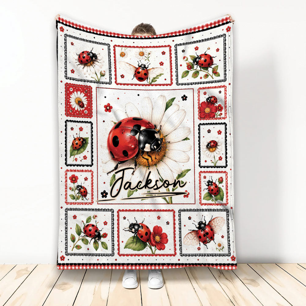 Ladybug throw blanket displayed upright with floral panels and red, black, and white garden artwork