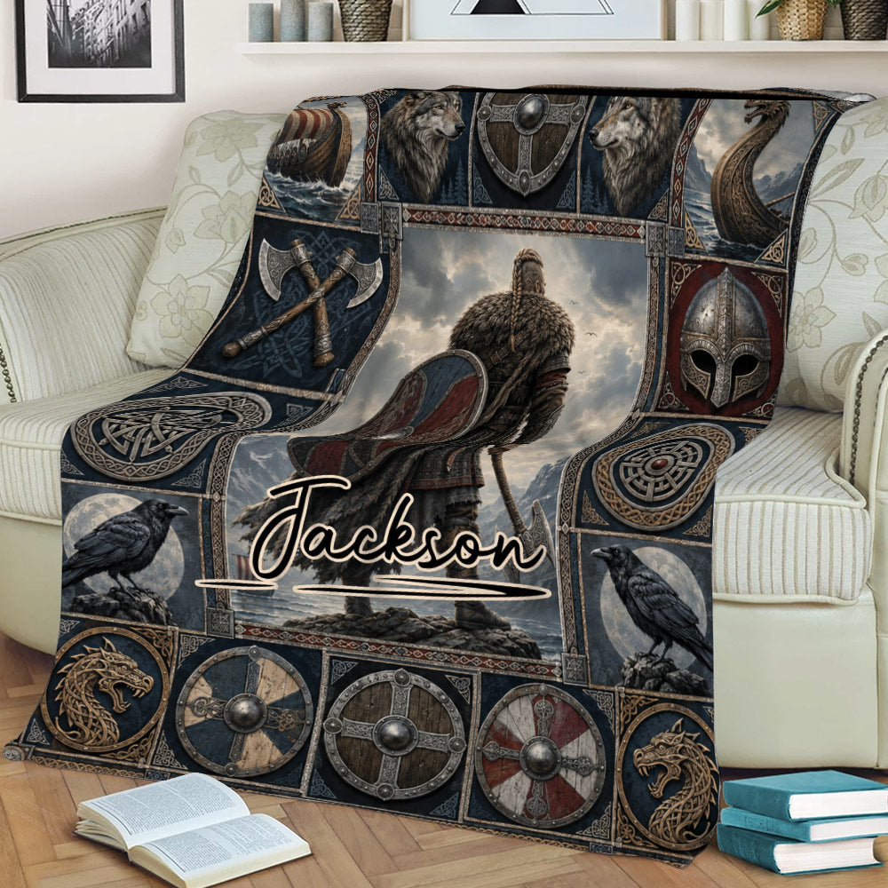 Norse Viking throw blanket displayed on a sofa with warrior, wolf, raven, shield, and longship artwork