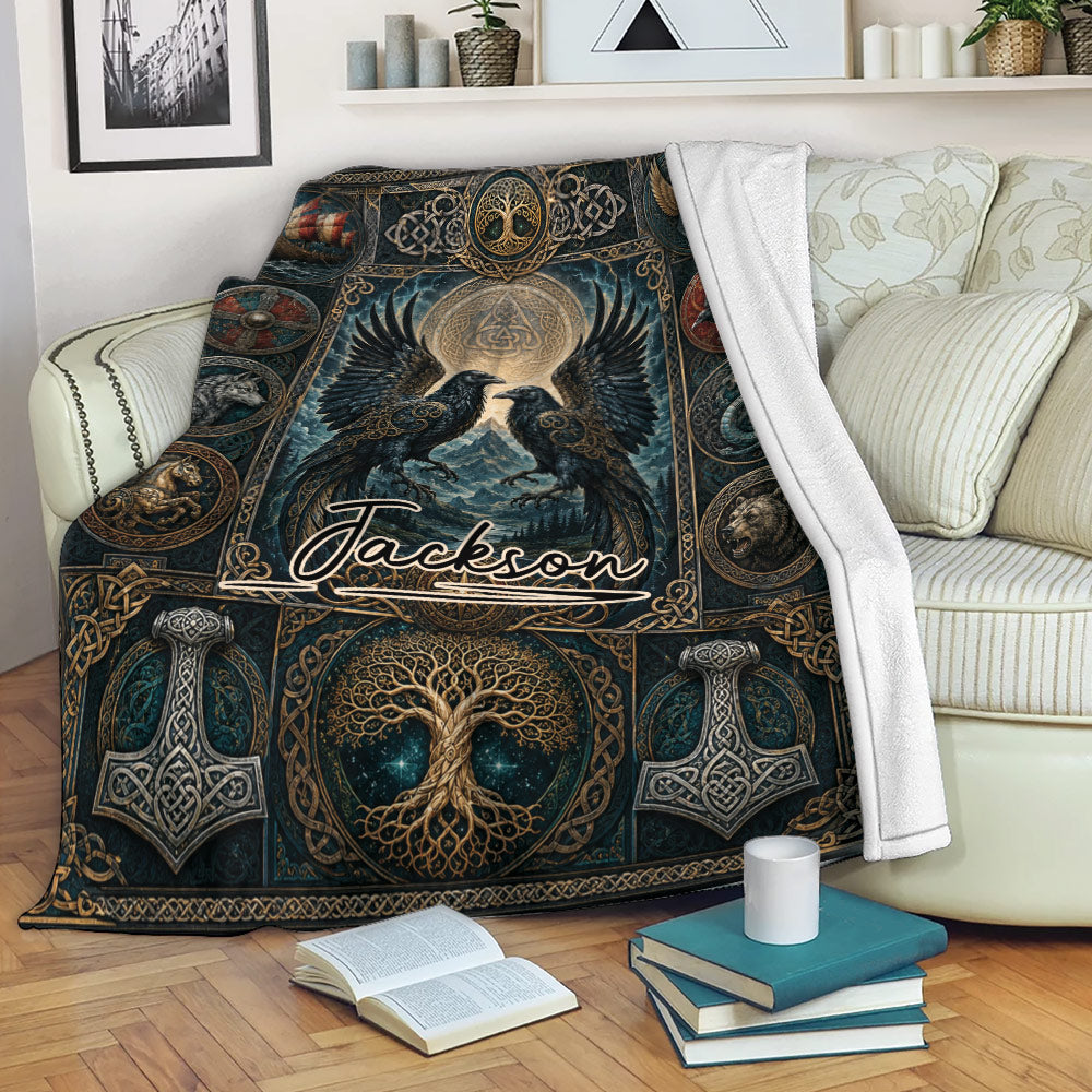 Viking throw blanket draped over a sofa with ravens, Norse symbols, and dark blue and gold artwork