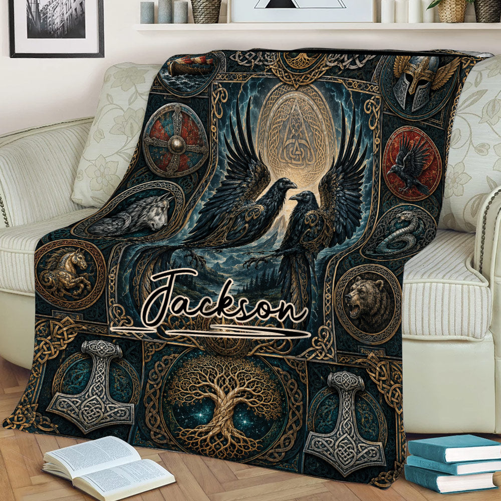Norse-inspired Viking blanket displayed on a sofa with ravens, a world tree, knotwork, and mythic emblems